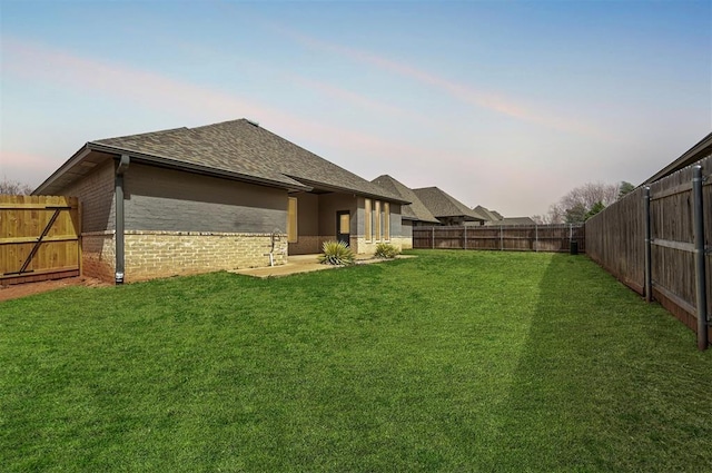 1548 NW 175th Ct, Edmond, OK 73012 - back of house at dusk with roof with shingles and brick siding