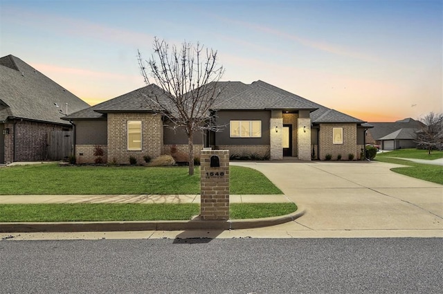 1548 NW 175th Ct, Edmond, OK 73012 - view of front of home featuring brick siding, a yard, roof with shingles, and concrete driveway