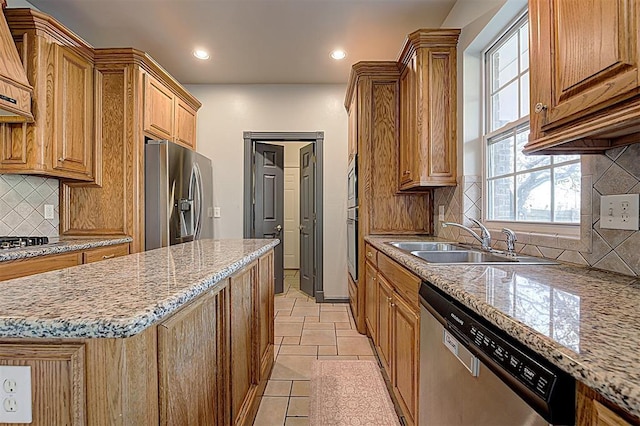 kitchen featuring a sink, a kitchen island, recessed lighting, appliances with stainless steel finishes, and decorative backsplash