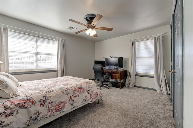 carpeted bedroom featuring visible vents and ceiling fan