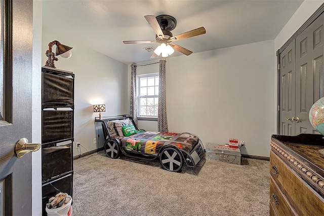 carpeted bedroom with a closet, visible vents, ceiling fan, and baseboards