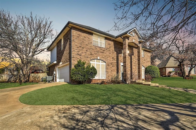 view of front facade with brick siding, concrete driveway, a front yard, cooling unit, and a garage