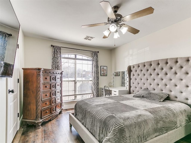 bedroom with wood finished floors, visible vents, and ceiling fan