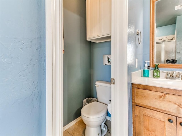 full bathroom featuring tile patterned floors, toilet, a shower, baseboards, and vanity