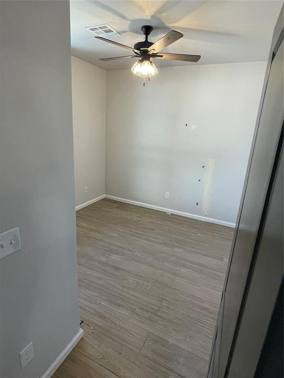 unfurnished room with ceiling fan and light hardwood / wood-style floors