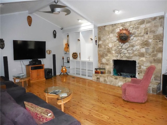 living room with wood-type flooring, a fireplace, and lofted ceiling with beams