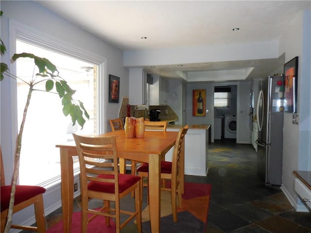 dining room with washer / clothes dryer and a wealth of natural light