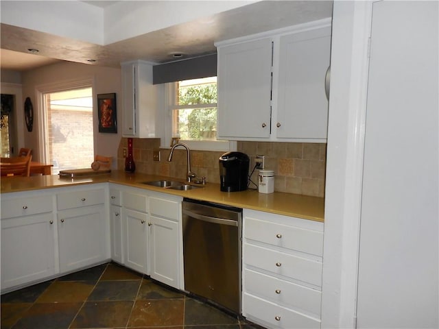 kitchen featuring sink, backsplash, white cabinets, and dishwasher