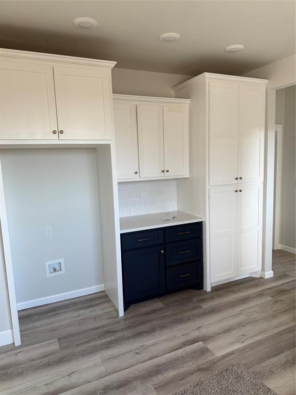 kitchen featuring white cabinetry and light wood-type flooring