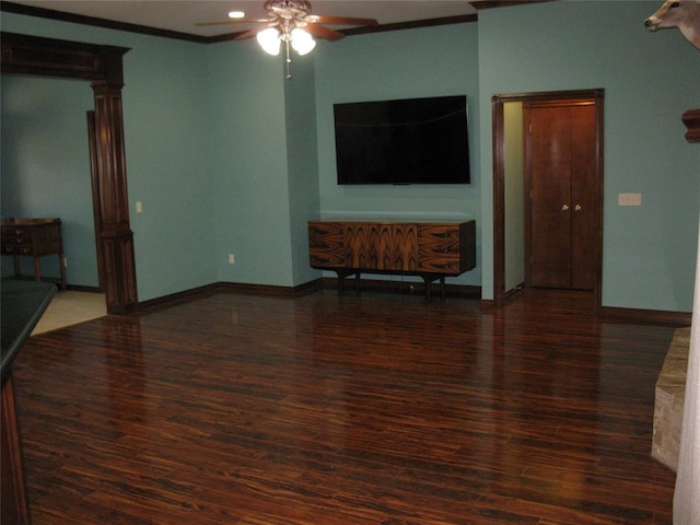 living room with dark wood-type flooring, ornamental molding, and ceiling fan