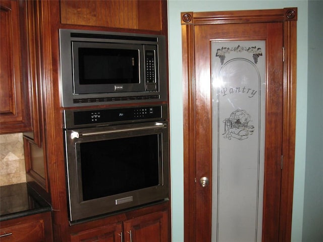 kitchen featuring stainless steel appliances and tasteful backsplash