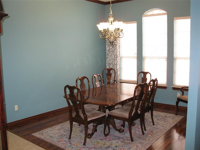 dining space with a notable chandelier, hardwood / wood-style floors, and a healthy amount of sunlight