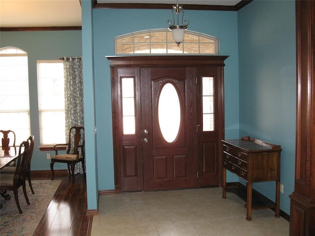 foyer featuring crown molding