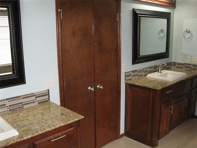 bathroom with vanity, decorative backsplash, and tile patterned floors