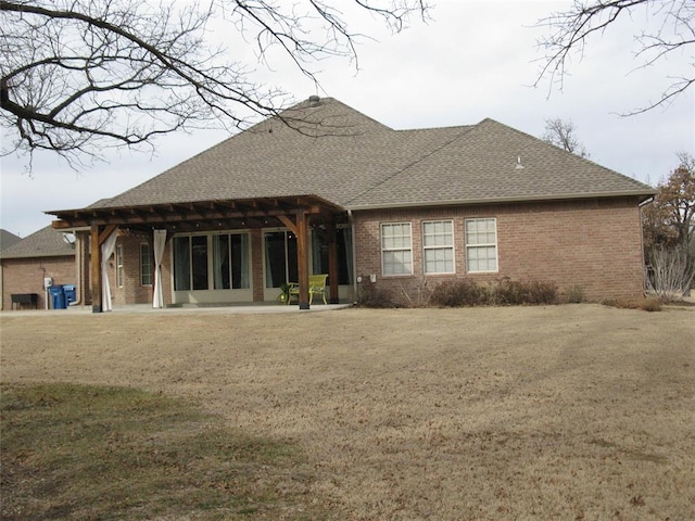 rear view of house with a yard and a patio area