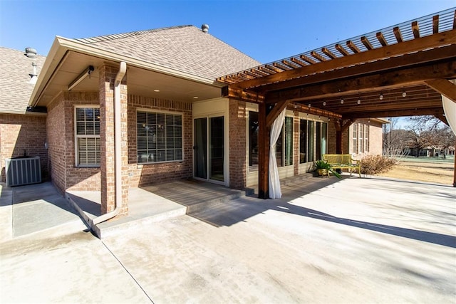 rear view of property with central AC unit and a patio area