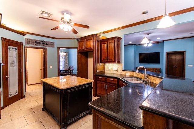 kitchen featuring sink, a center island, hanging light fixtures, ornamental molding, and decorative backsplash