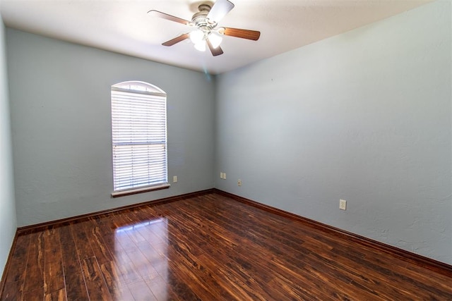 unfurnished room with dark wood-type flooring and ceiling fan