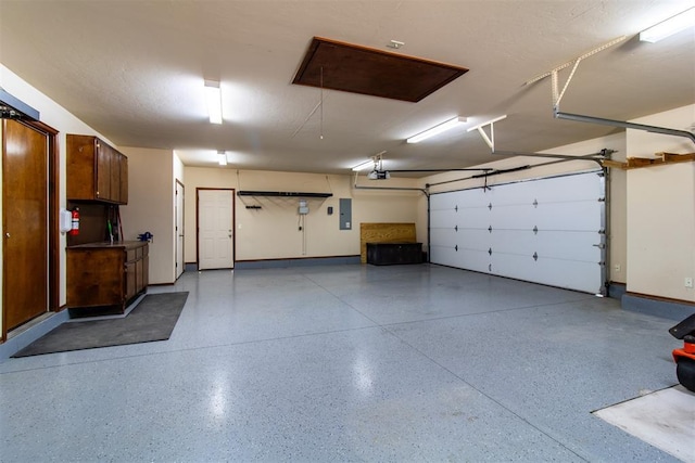 garage featuring a garage door opener and electric panel