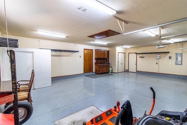 garage with a garage door opener and electric panel