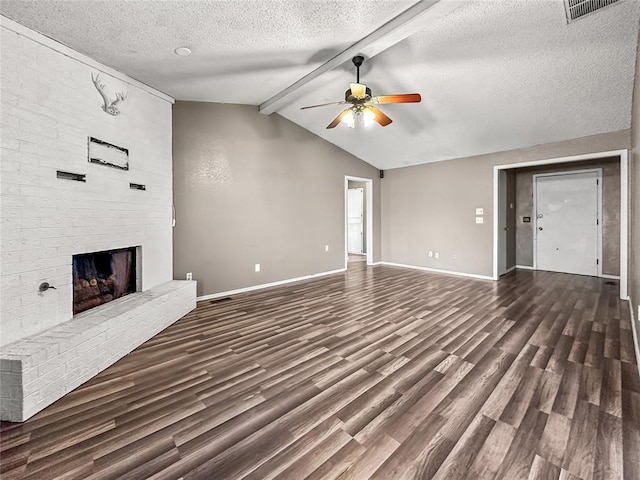 unfurnished living room with ceiling fan, vaulted ceiling with beams, dark hardwood / wood-style floors, a textured ceiling, and a brick fireplace