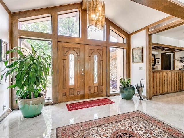 entrance foyer featuring high vaulted ceiling and a notable chandelier