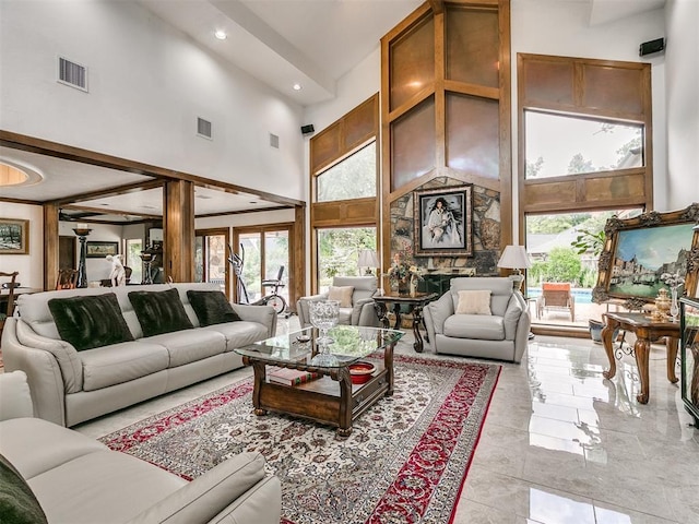 living room featuring a healthy amount of sunlight and a high ceiling