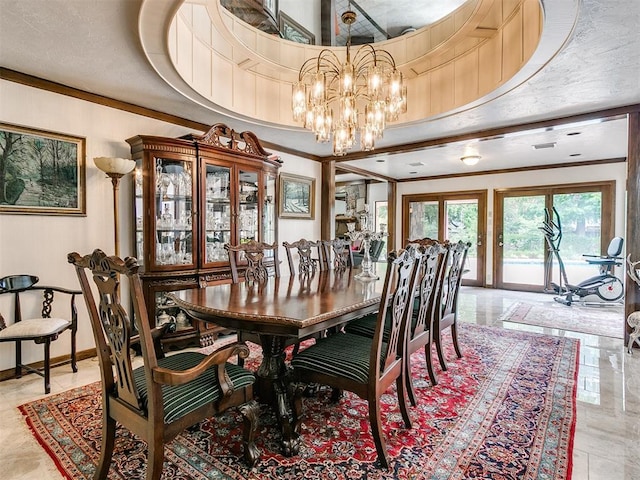 dining area with crown molding, a notable chandelier, and a tray ceiling