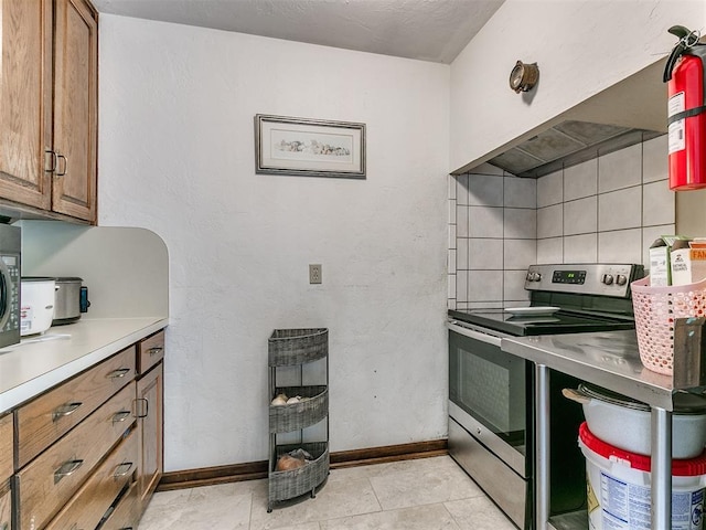 kitchen featuring backsplash and stainless steel electric stove