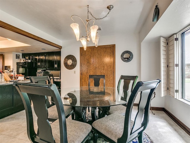 dining room featuring a healthy amount of sunlight and a chandelier