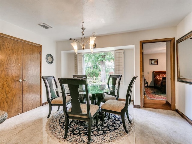 dining area featuring a notable chandelier