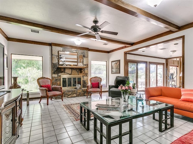 living room with light tile patterned floors, a fireplace, beamed ceiling, and a healthy amount of sunlight