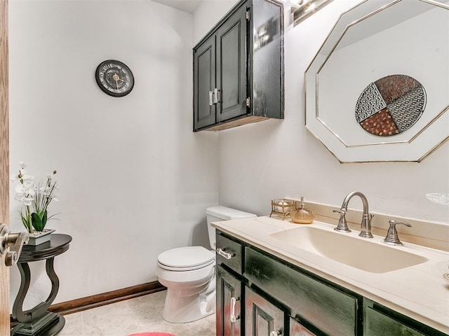 bathroom featuring vanity, tile patterned flooring, and toilet