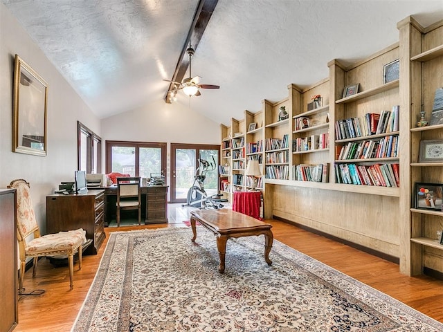 sitting room featuring lofted ceiling with beams, ceiling fan, and light hardwood / wood-style flooring