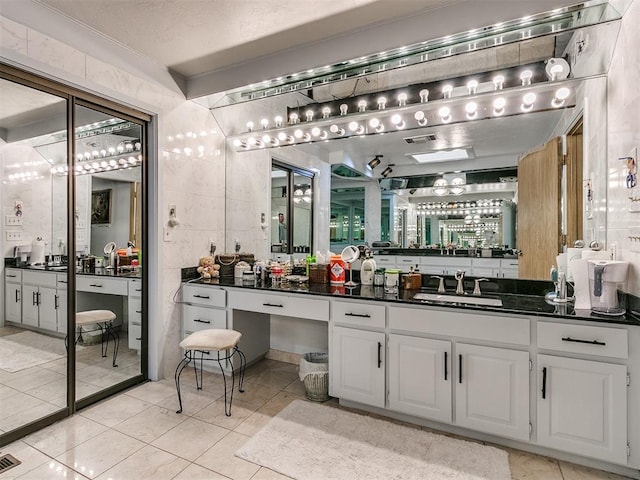 bathroom featuring tile walls, vanity, crown molding, and tile patterned floors