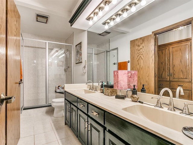 bathroom featuring vanity, toilet, tile patterned floors, and walk in shower