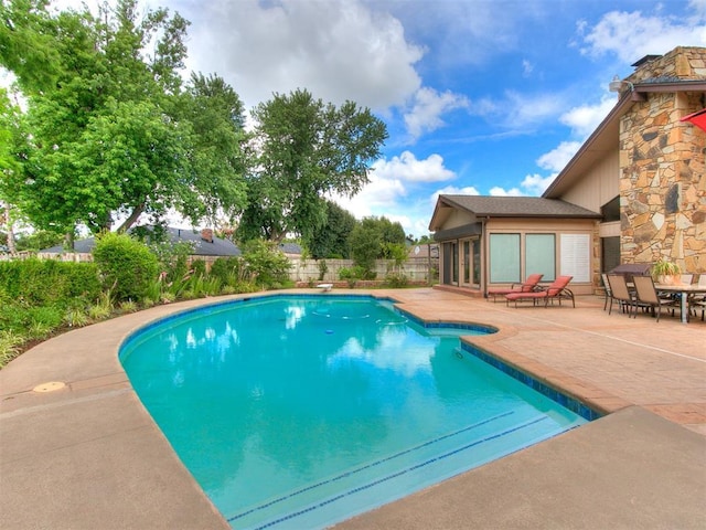 view of pool featuring a patio and a diving board