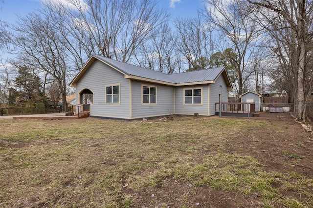 view of side of property featuring a wooden deck and a yard