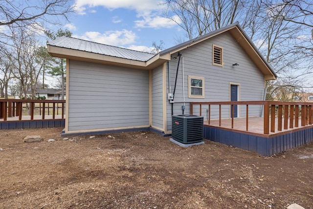 back of property with a deck and central AC unit