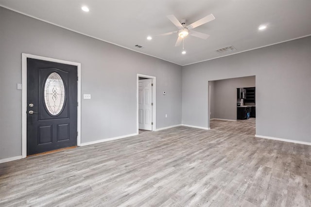 foyer entrance featuring ceiling fan and light wood-type flooring