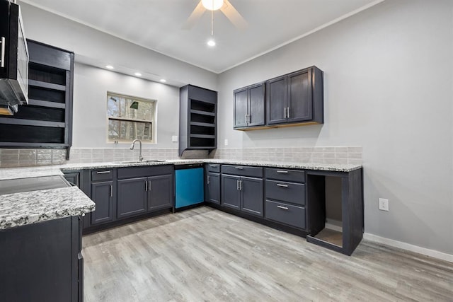 kitchen featuring light stone counters, sink, decorative backsplash, and appliances with stainless steel finishes