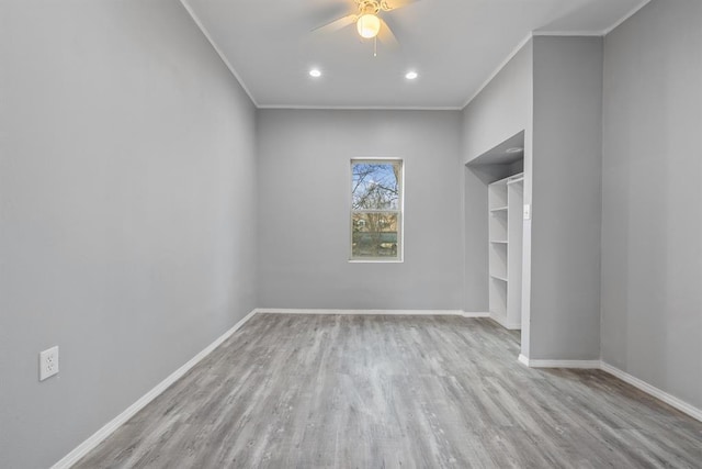 unfurnished room with ceiling fan, ornamental molding, and light wood-type flooring