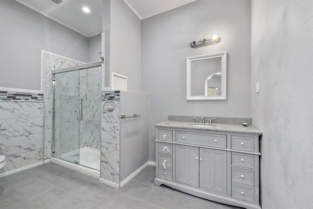 bathroom with vanity, tile patterned floors, ornamental molding, and walk in shower