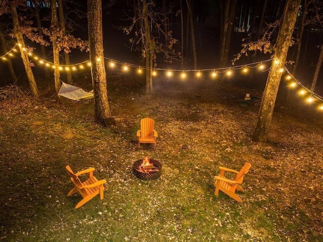 yard at night with a fire pit