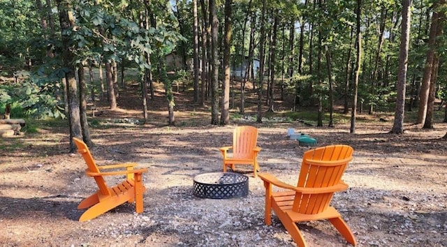 view of yard with a fire pit