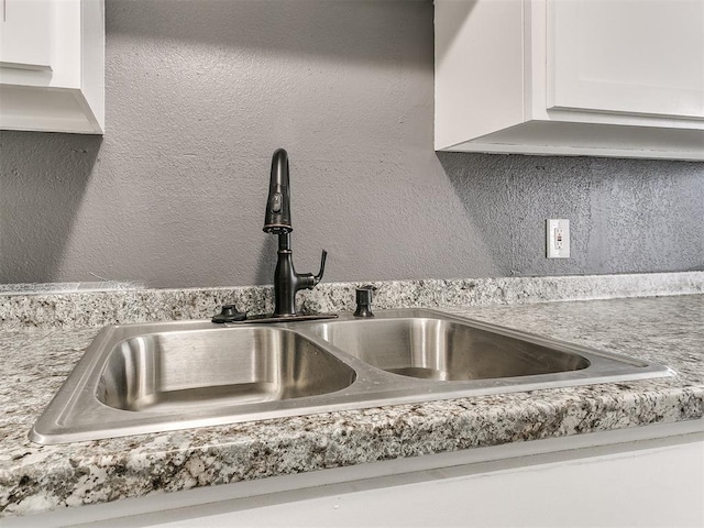 details featuring sink and white cabinets