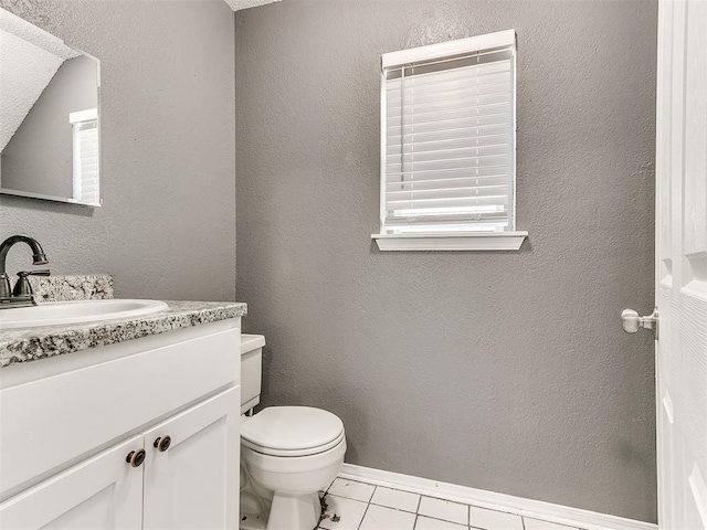 bathroom featuring vanity, tile patterned floors, and toilet