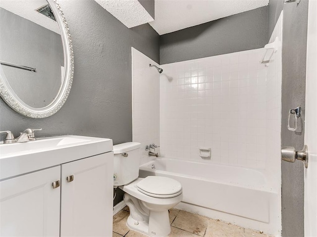 full bathroom featuring tiled shower / bath combo, vanity, tile patterned floors, and toilet