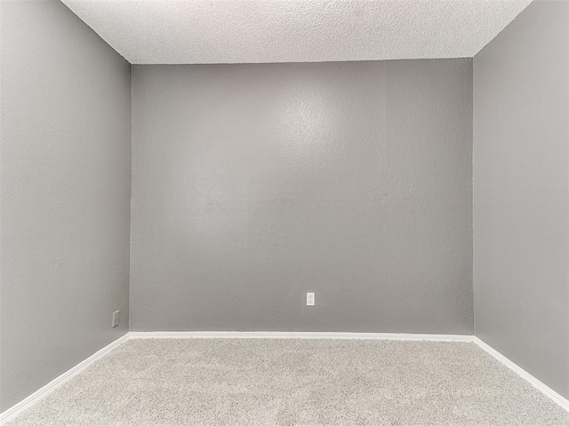 spare room with carpet and a textured ceiling