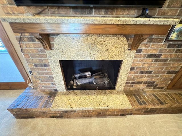 details featuring a fireplace and carpet flooring